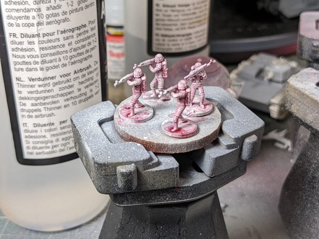 Four cosmonauts half painted on a painting handle
